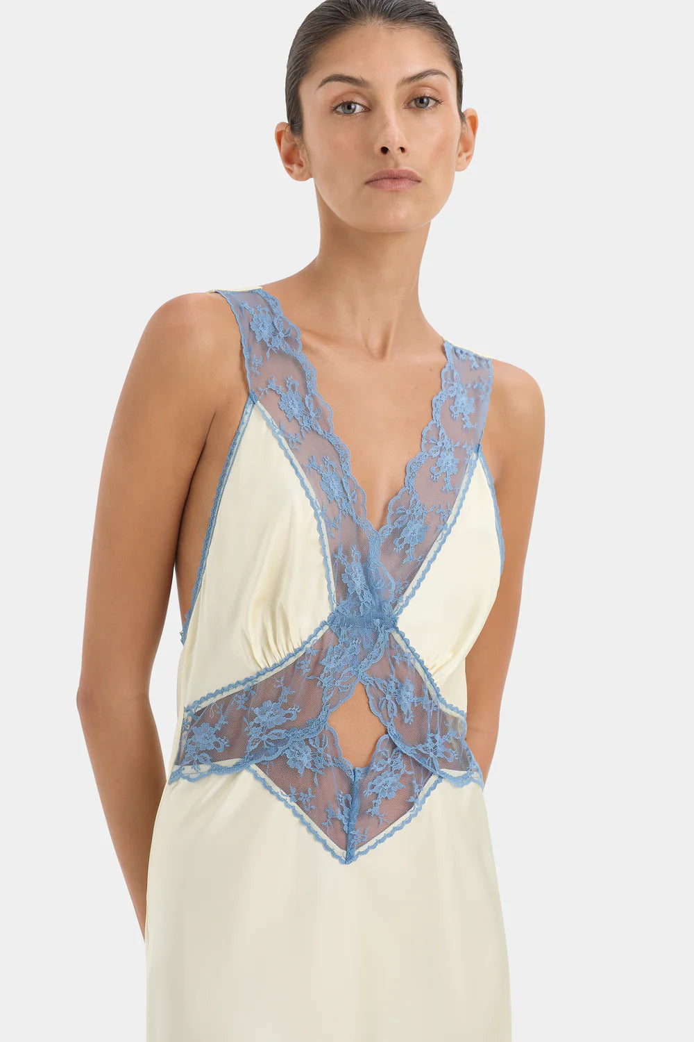 Close up image of blue floral lace trim on the Aries Cut Out Gown by SIR. Same and next day dispatch available for last minute dress hires.