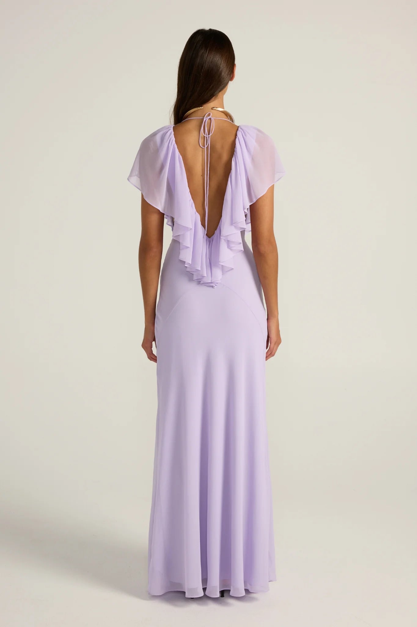 Ance Gria Clover Gown in Lavender. A low-plunge V neck, framed by a gorgeous frilled mane. Sydney & Melbourne Garment Rentals with Fast Shipping and Returns Made Simple!