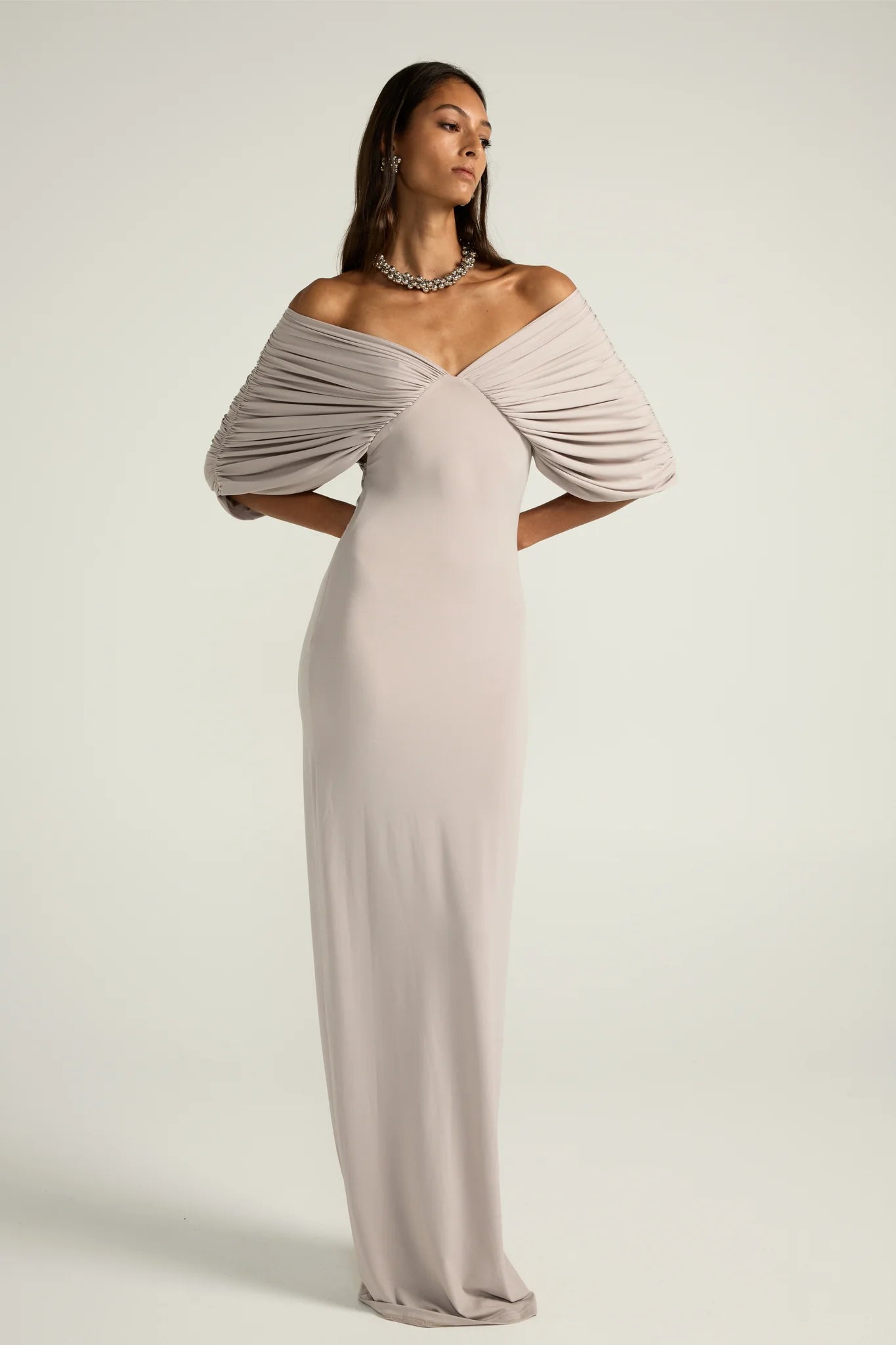 Ance Gria Neve Dress Hire in Silver Grey. Swan like 3/4 sleeves and a floor-length skirt. Local Perth Dress Hire Try-Ons & Collections also available. Book now!