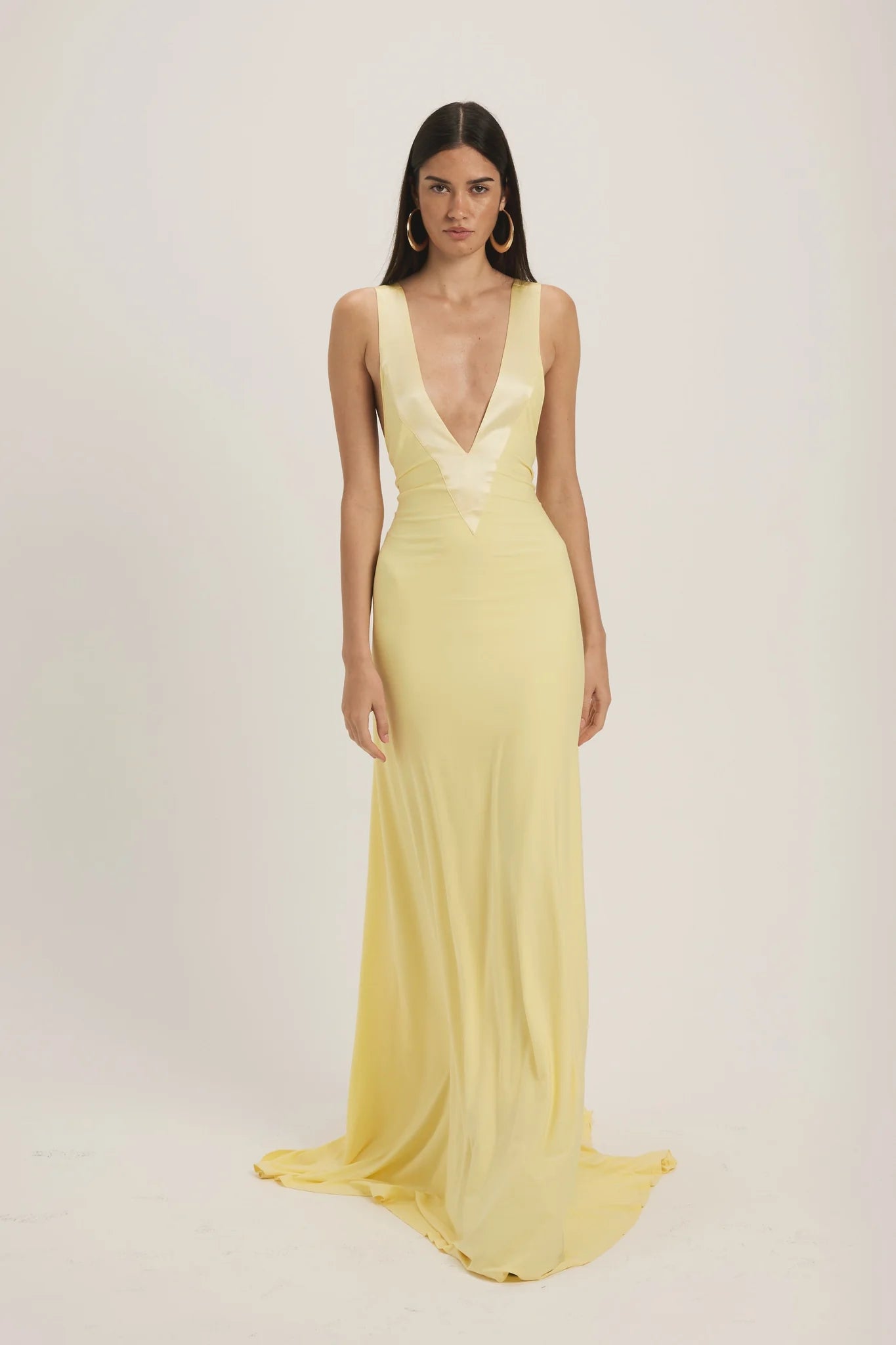 Ance Gria Rosa Gown Hire in Yellow. A plunging V-Neck in 100% Silk Lace Trim, in an elegant yellow gown made from soft-jersey fabric. Secure a date with our Perth Dress & Gown Hires today.