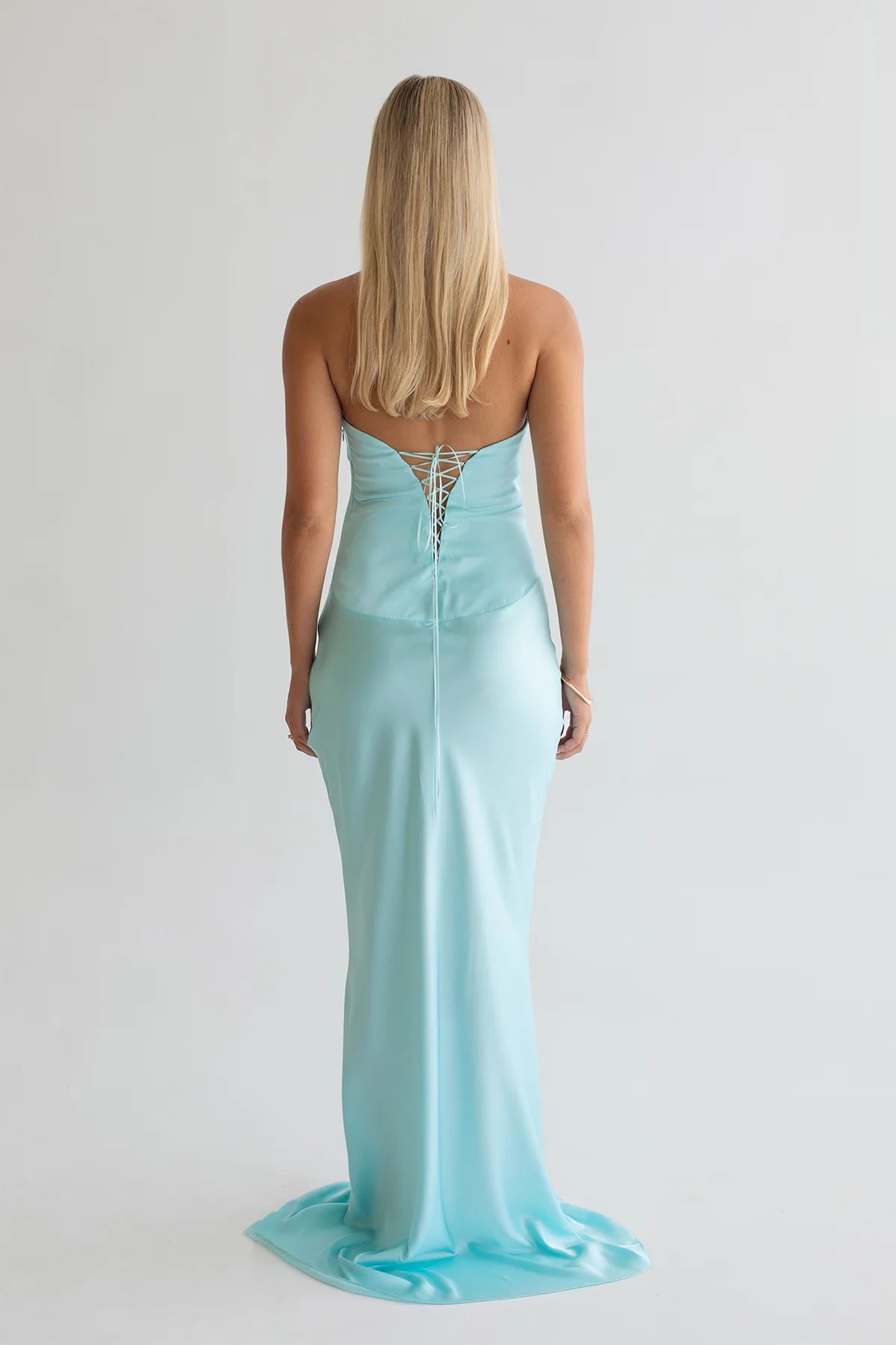 Back view Ashton Gown in Aqua (vibrant sky blue) by Hntr (Hunter) the Label. Tie-up faux corset and long maxi gown Hire. Australia-wide express shipping or local Perth collection available.