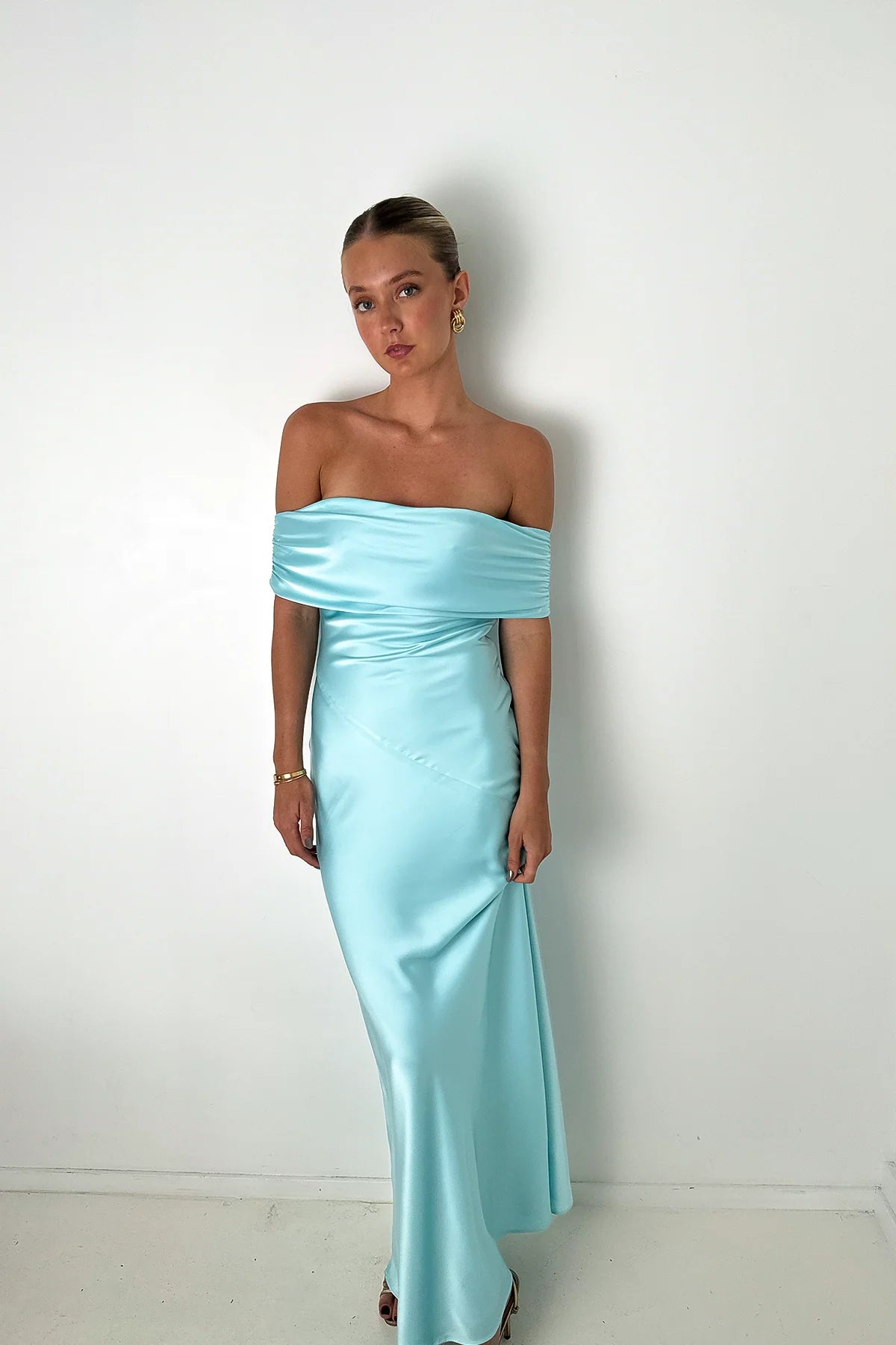 Off-the-shoulder, light blue/turquoise formal dress. Hntr the Label rentals, at Cc Dress Hire. Secure your date, today!
