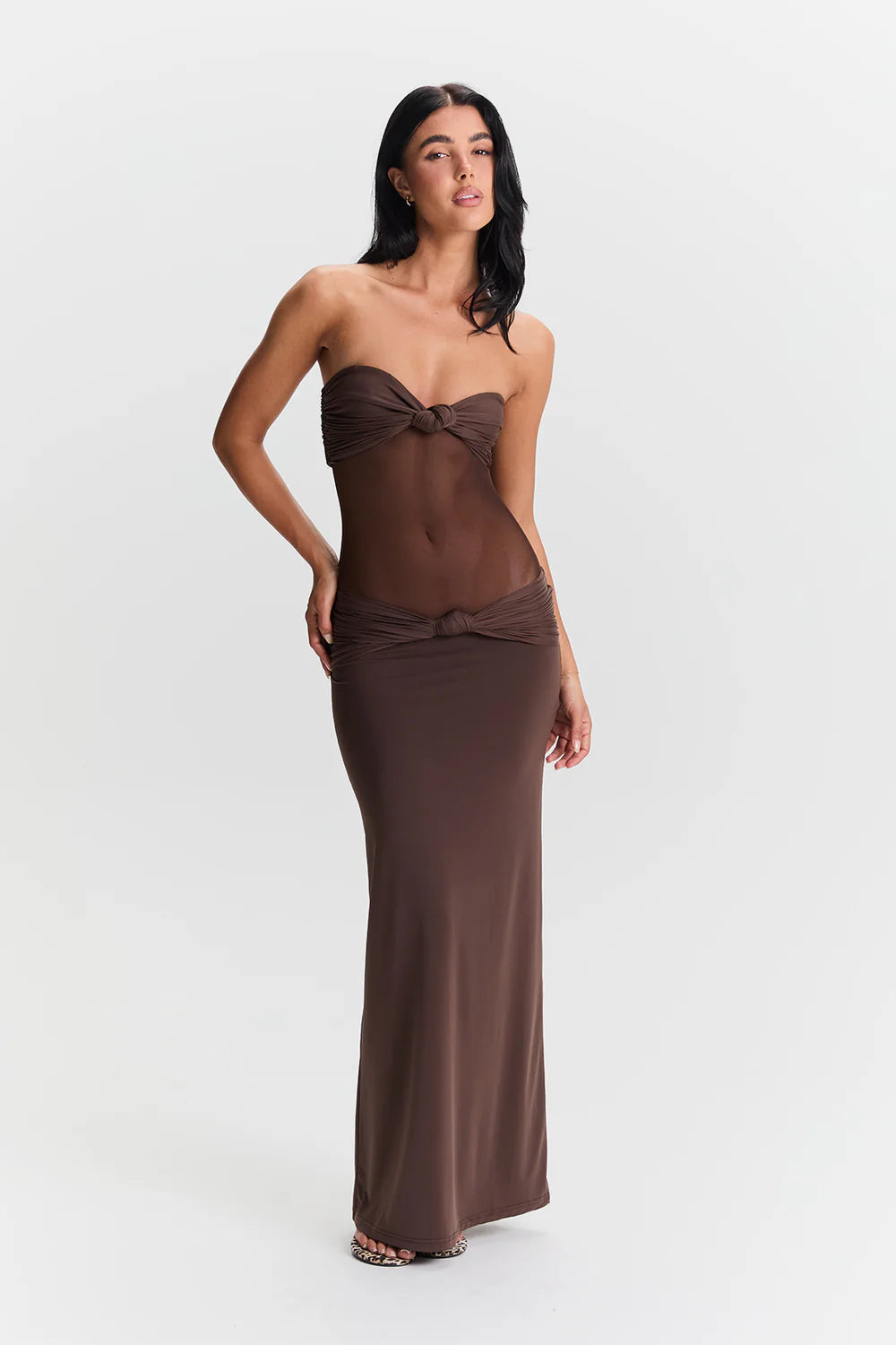 Sasha Therese Amara Maxi Dress Hire in Brown. Bust features a bridge twist, with a sheer bodice meeting a low-rise maxi-length skirt. Dress Hire Perth - with in-store try-ons and pickups. Book now!